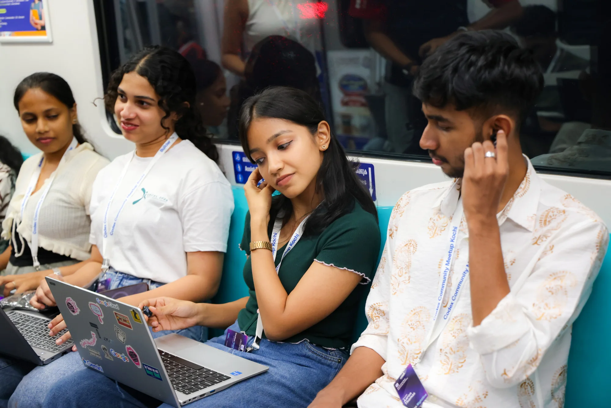 A row of Codex Nightline participants working on laptops