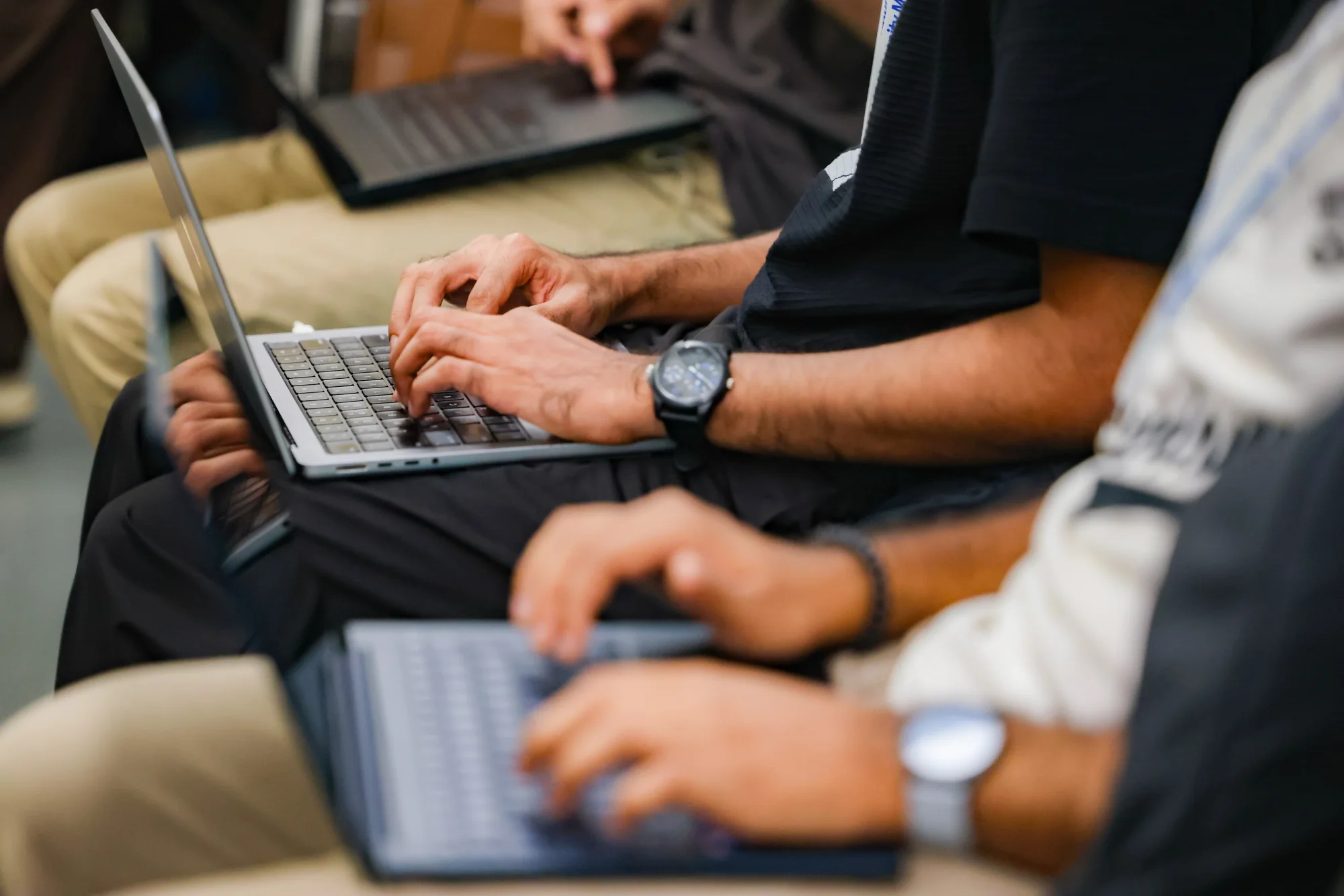 Hands typing on laptops during the AI build sprint